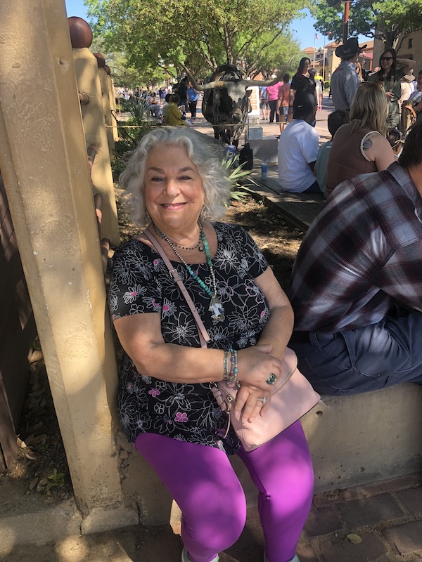 Me sitting on a retaining wall in the shade at The Stockyards Fort Worth Texas