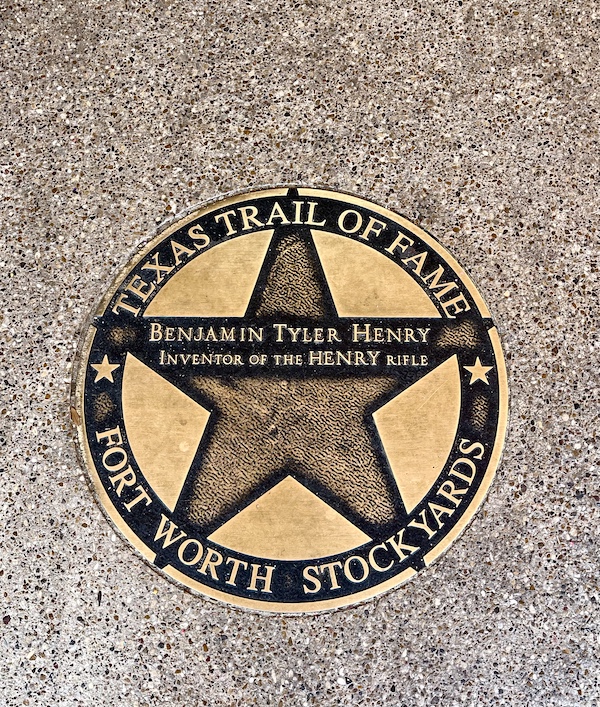 Bronze star embedded in the red brick paver sidewalk at The Stockyards Fort Worth Texas honoring Benjamin Henry
