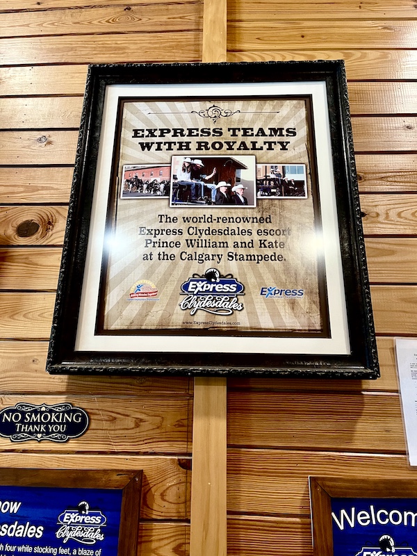 A wall plaque hanging in the barn at Express Clydesdales Yukon Oklahoma tells about the horses as escorts for royalty.