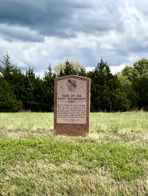 Happy 100 Route 66! Red stone historic monument on the side of the road along Route 66 in Oklahoma