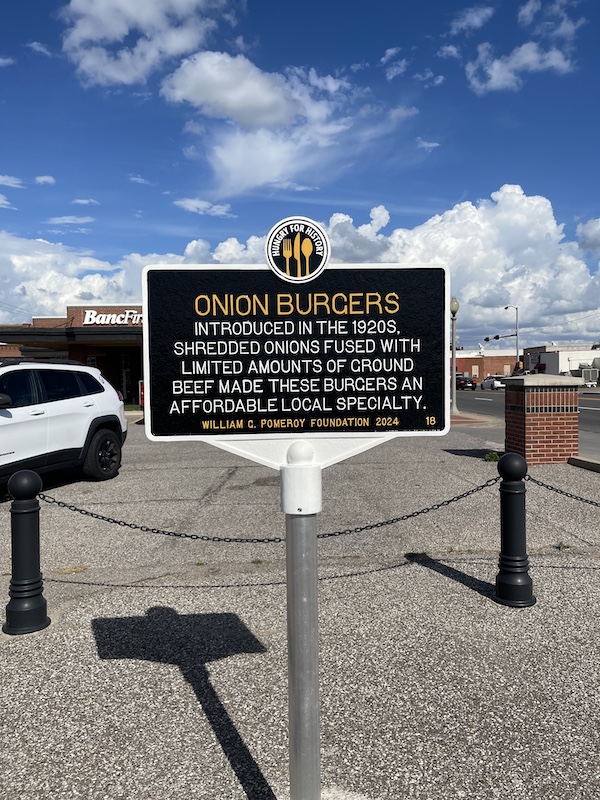 Happy 100 Route 66! Black and gold historic marker for onion burgers.